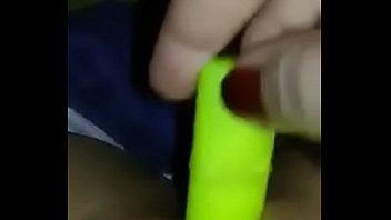 Girl masturbates with little green toy